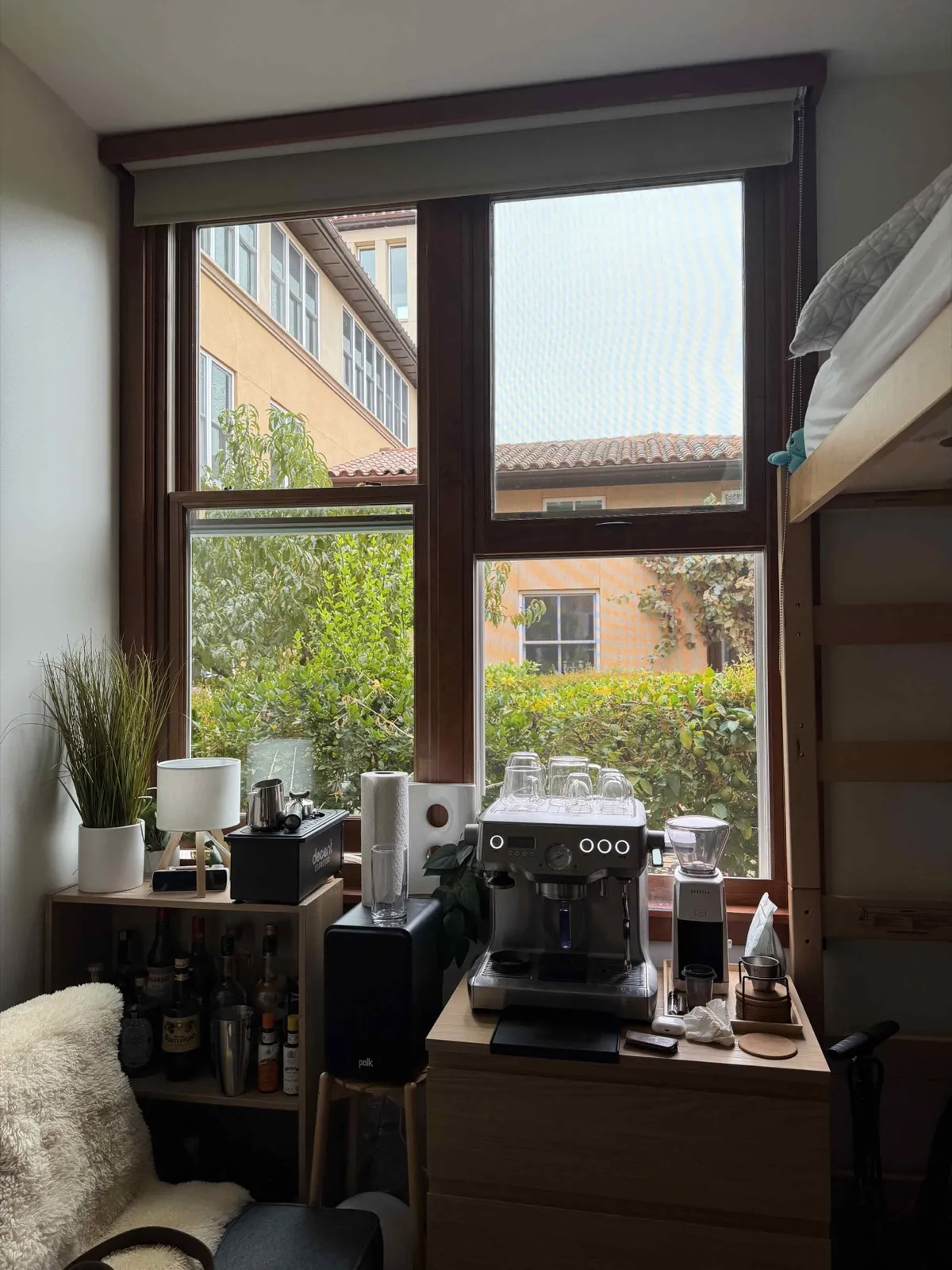 An espresso setup below a dorm window.